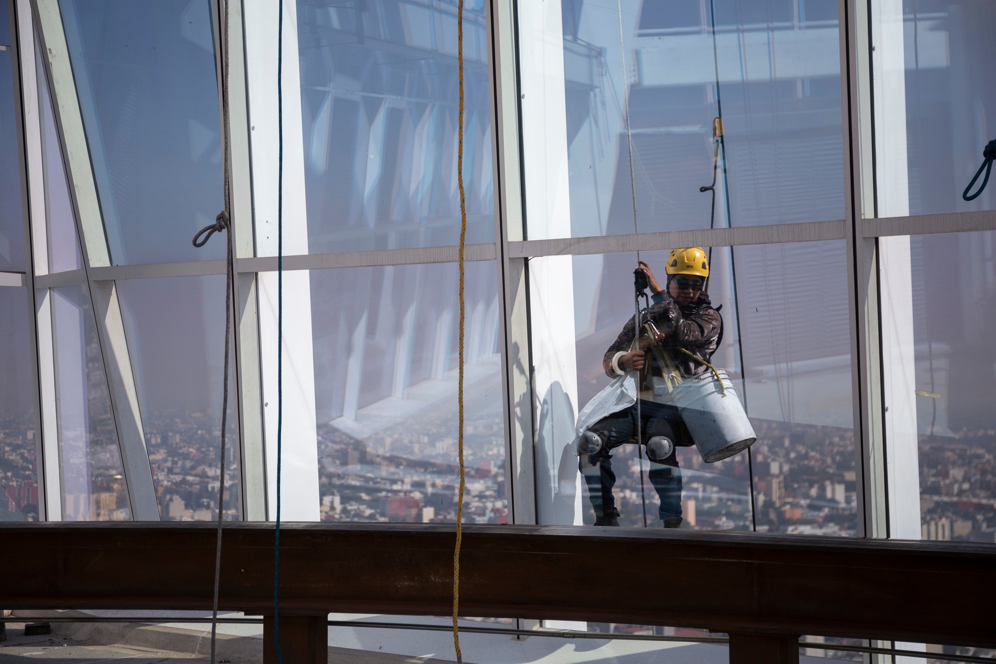 Worker cleaning windows of a skyscraper.
